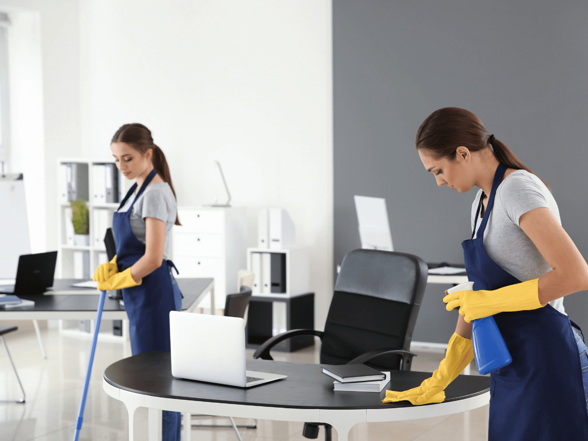 two cleaners performing regular commercial cleaning in an office